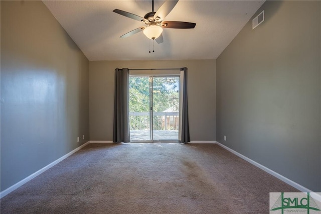 carpeted spare room with visible vents, baseboards, lofted ceiling, and a ceiling fan