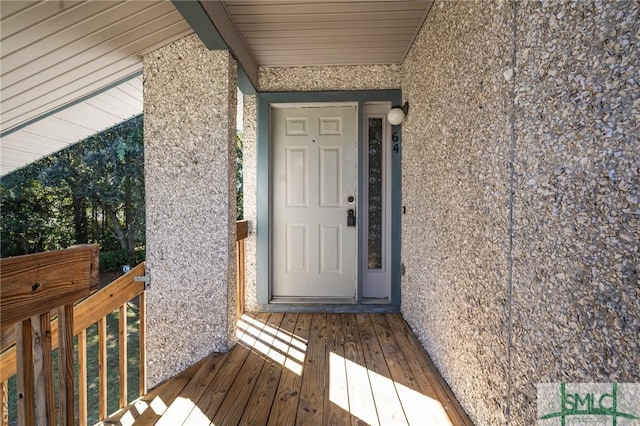 doorway to property featuring stucco siding