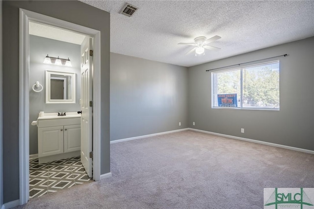 unfurnished bedroom featuring visible vents, baseboards, carpet, and a sink