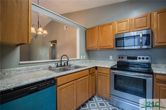 kitchen featuring visible vents, an inviting chandelier, a sink, light countertops, and appliances with stainless steel finishes