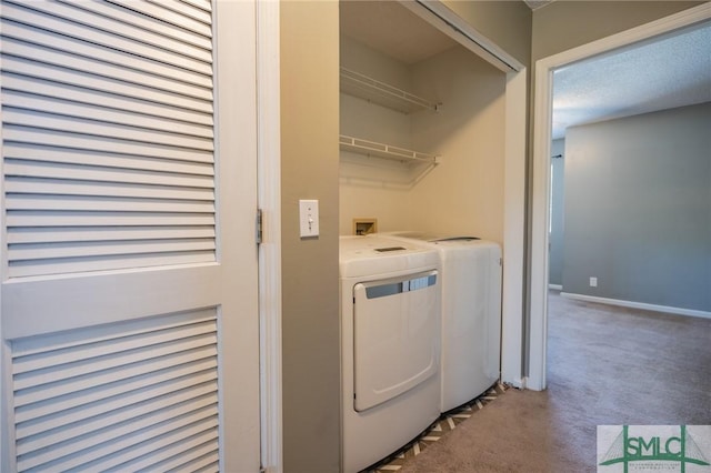 laundry room with laundry area, washer and dryer, baseboards, and carpet