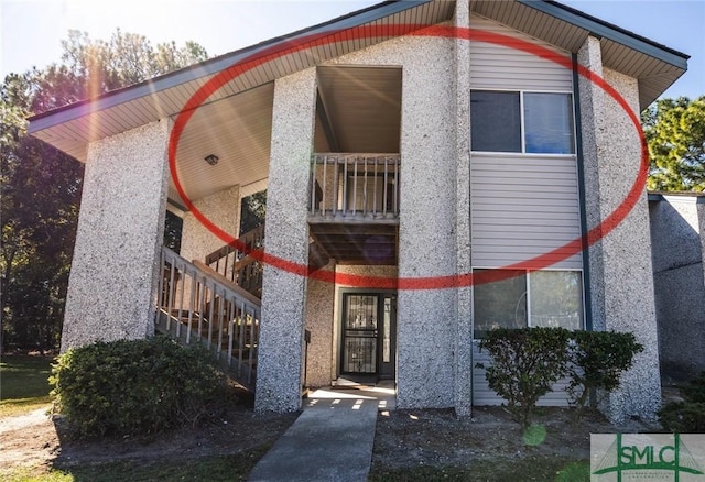 view of front of house featuring a balcony