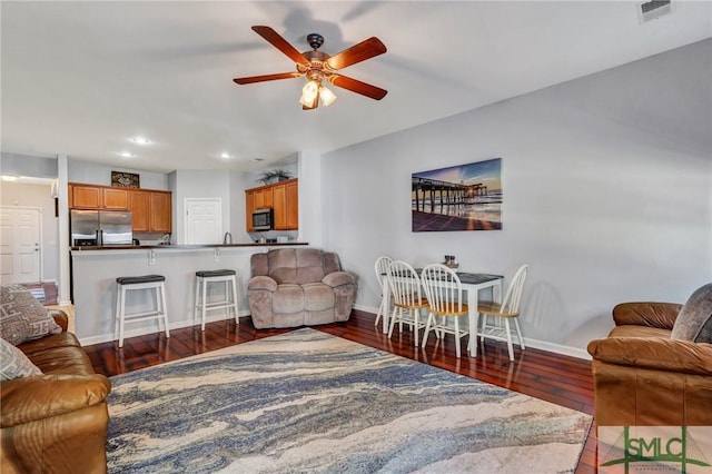 living room with recessed lighting, baseboards, wood finished floors, and a ceiling fan