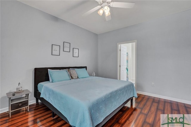 bedroom featuring a ceiling fan, wood finished floors, baseboards, and ensuite bathroom