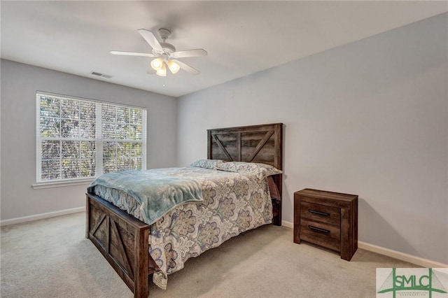 carpeted bedroom with visible vents, baseboards, and ceiling fan