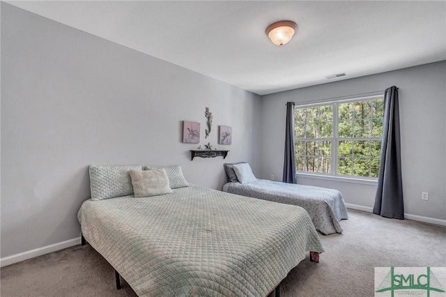 carpeted bedroom with visible vents and baseboards