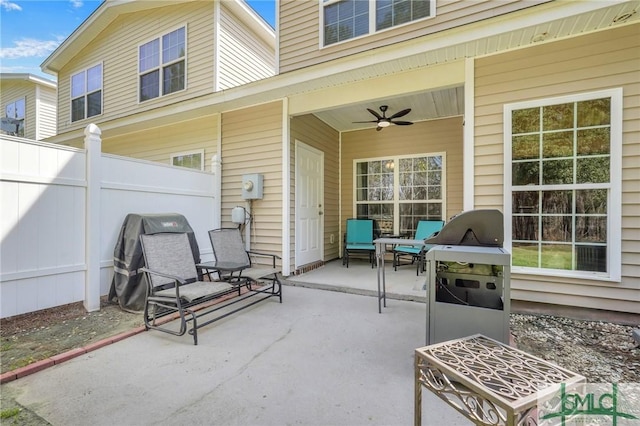 view of patio / terrace featuring area for grilling, a ceiling fan, and fence