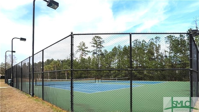 view of sport court featuring fence