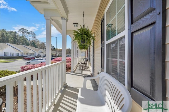 balcony featuring a residential view and covered porch