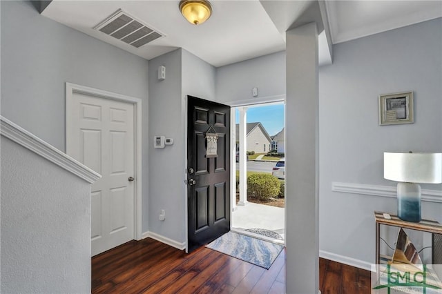 entryway with visible vents, baseboards, and wood finished floors