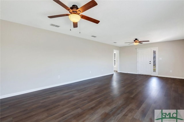 unfurnished living room with visible vents, baseboards, dark wood-style floors, and a ceiling fan