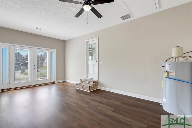 interior space with ceiling fan, water heater, french doors, dark wood-style floors, and a textured ceiling