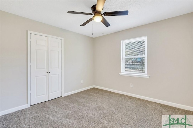 unfurnished bedroom with a closet, baseboards, carpet floors, and ceiling fan