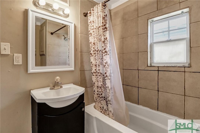 full bath featuring vanity and shower / tub combo