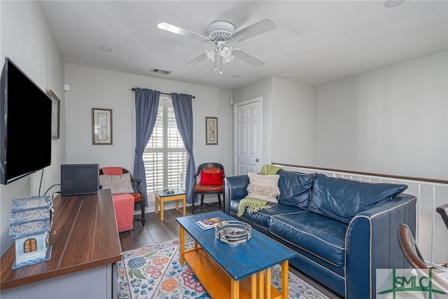 living area featuring visible vents, ceiling fan, and wood finished floors