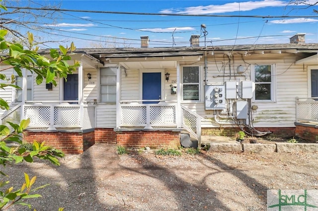 view of front of property with a porch and a chimney