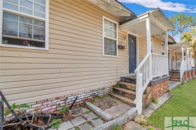 view of exterior entry with a porch