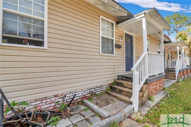 view of exterior entry featuring a porch