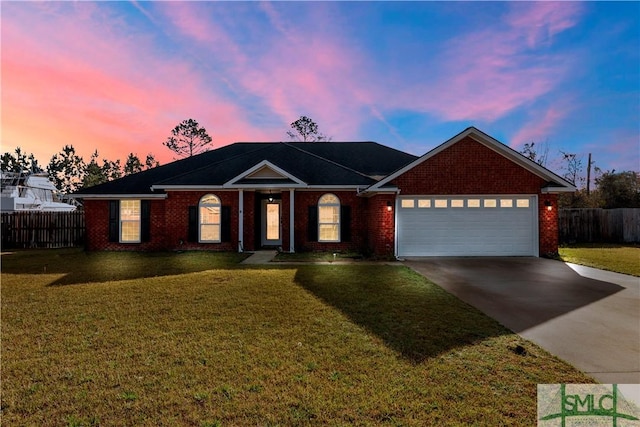 ranch-style home featuring a yard, a garage, driveway, and fence