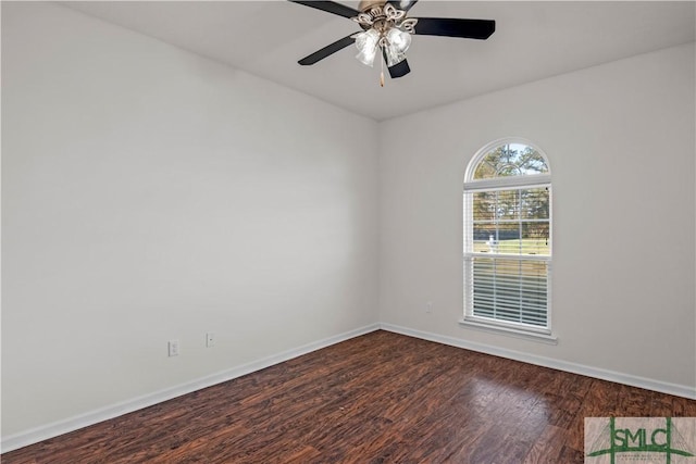 unfurnished room with a ceiling fan, dark wood-style floors, and baseboards