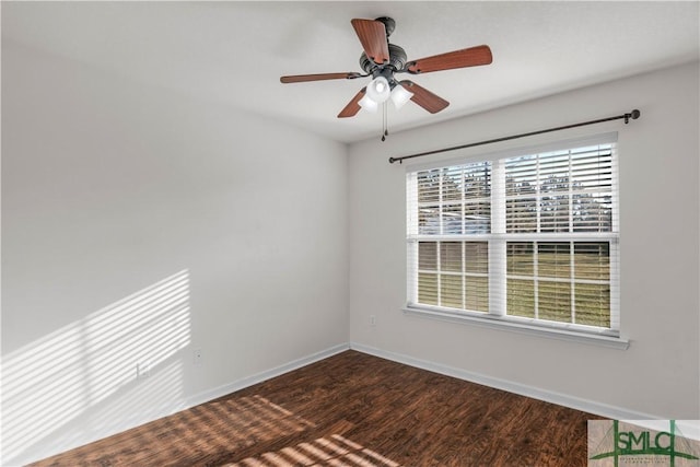 empty room with a ceiling fan, baseboards, and dark wood-style flooring