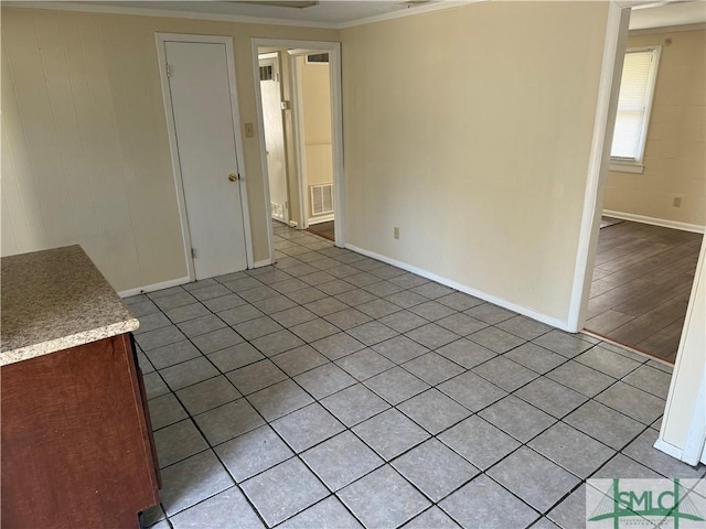 unfurnished room with crown molding, baseboards, and visible vents