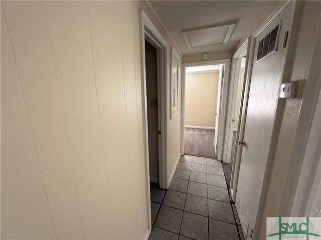 hall featuring tile patterned flooring and visible vents