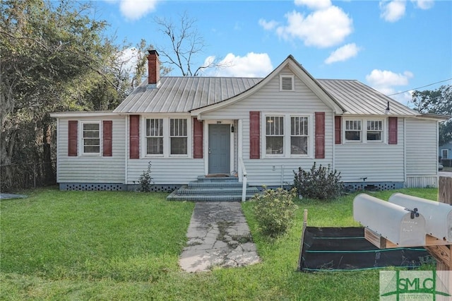 view of front of property featuring metal roof, a chimney, a front yard, and fence