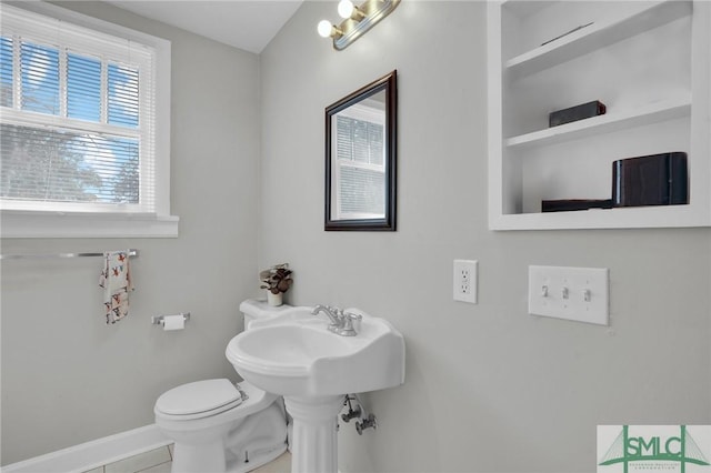 bathroom with tile patterned floors, toilet, and baseboards