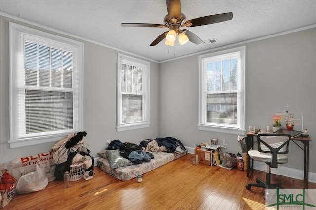 misc room with visible vents, a healthy amount of sunlight, and crown molding