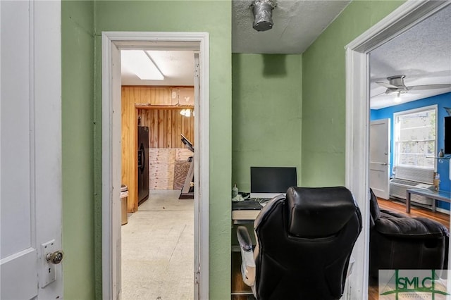 office with a textured ceiling and a ceiling fan