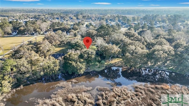 birds eye view of property featuring a wooded view