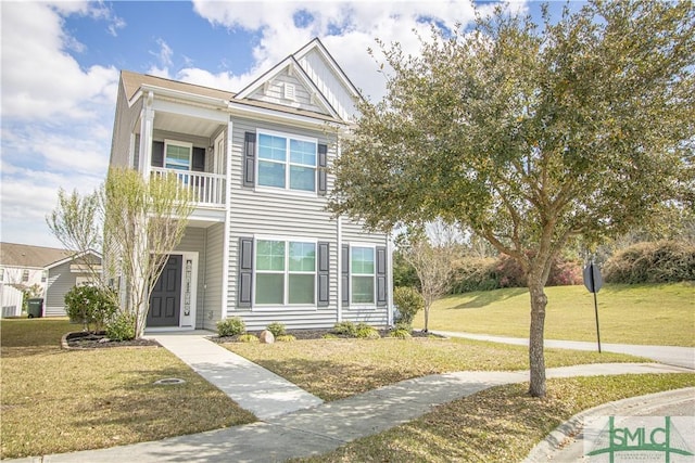 view of front of house with a balcony and a front yard