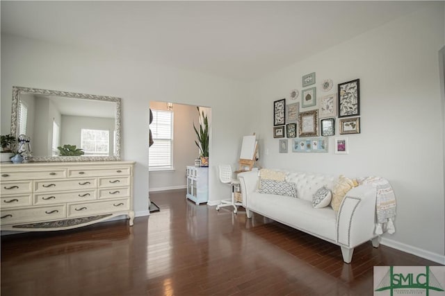 living area featuring baseboards and wood finished floors