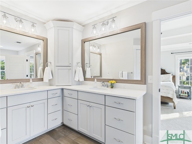 ensuite bathroom featuring a sink, visible vents, ensuite bathroom, and double vanity