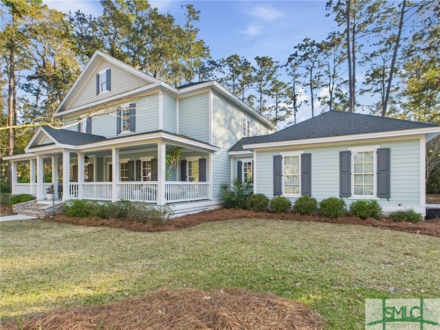 view of front of property with covered porch, a front lawn, and a shingled roof