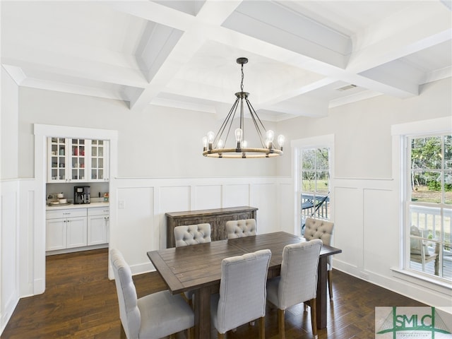 dining space featuring beamed ceiling, a notable chandelier, and plenty of natural light