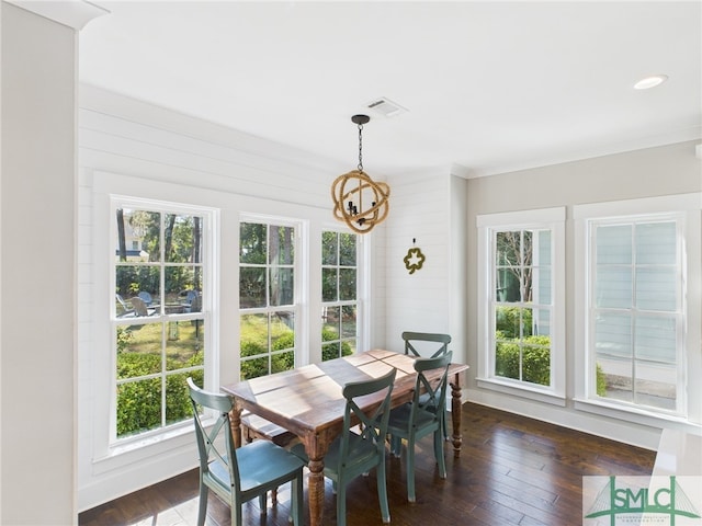 dining area with a chandelier, visible vents, and dark wood finished floors