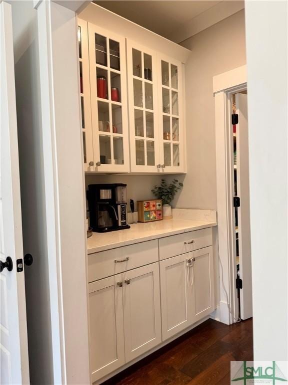 bar featuring dark wood-style floors