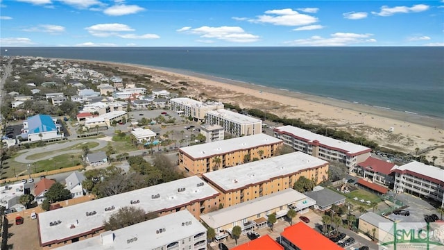 birds eye view of property featuring a water view and a view of the beach