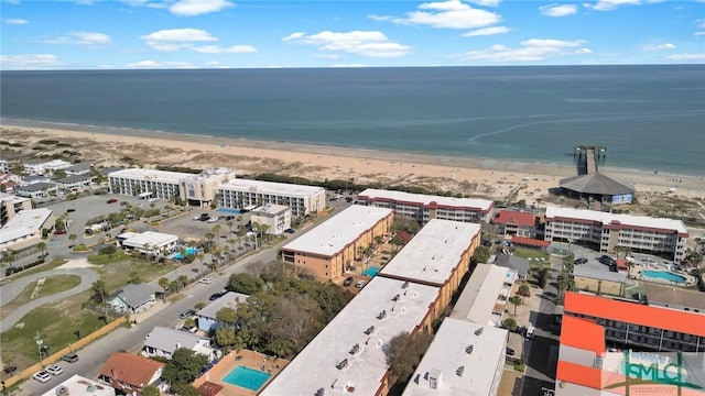 drone / aerial view featuring a beach view and a water view