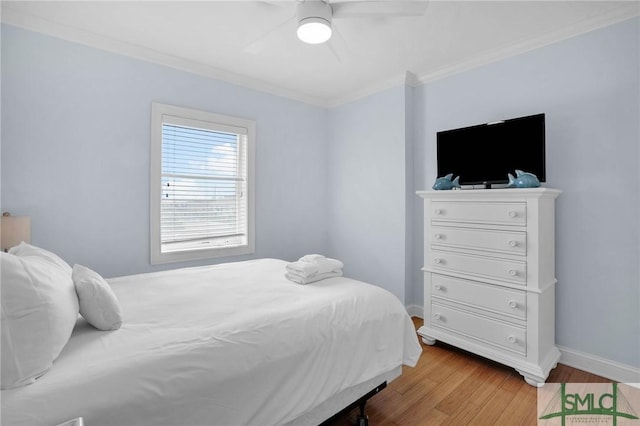 bedroom with ceiling fan, crown molding, light wood-type flooring, and baseboards