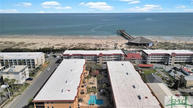 birds eye view of property featuring a beach view and a water view