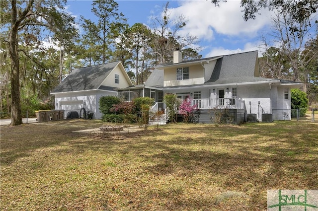 181 Kolic Helmey Rd, Guyton, GA 31312 - view of front of property featuring a sunroom, a front yard, brick siding, an attached garage, and a chimney