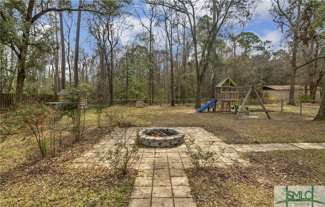 181 Kolic Helmey Rd, Guyton, GA 31312 - view of yard with a fire pit, a fenced backyard, and a playground