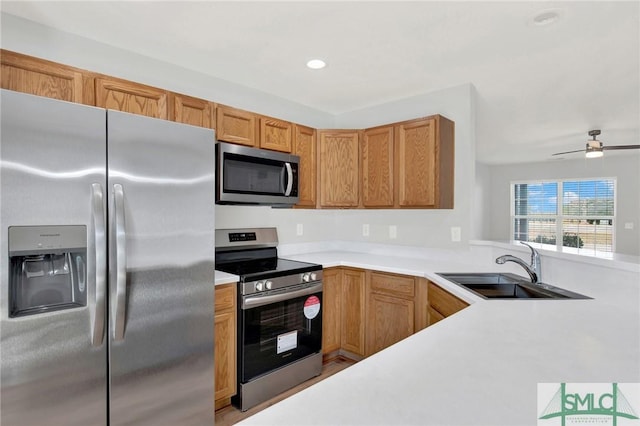 kitchen featuring a sink, stainless steel appliances, and light countertops