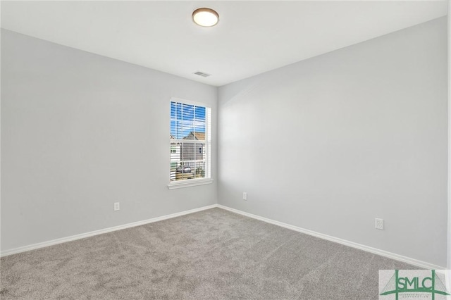 carpeted empty room with visible vents and baseboards