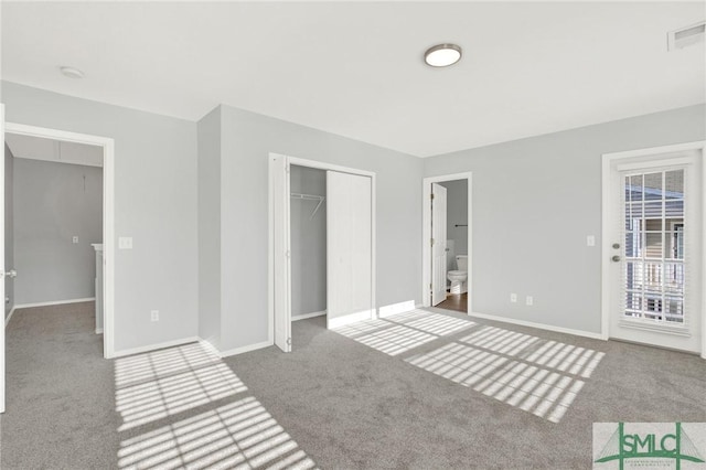 unfurnished bedroom featuring visible vents, a closet, carpet, baseboards, and access to exterior