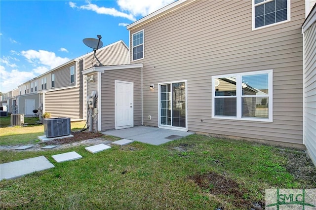 back of house with a patio, a yard, and central AC