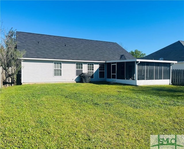 270 Lancaster Way, Richmond Hill, GA 31324 - rear view of house with a lawn, fence, roof with shingles, and a sunroom